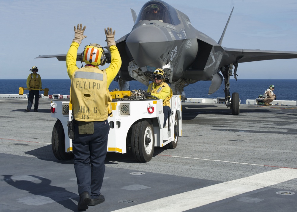 An F-35B Lightning II aircraft is taxied on the flight deck of amphibious assault ship USS America  (U.S. Navy photo by Petty Officer 1st Class Benjamin Wooddy/Released)